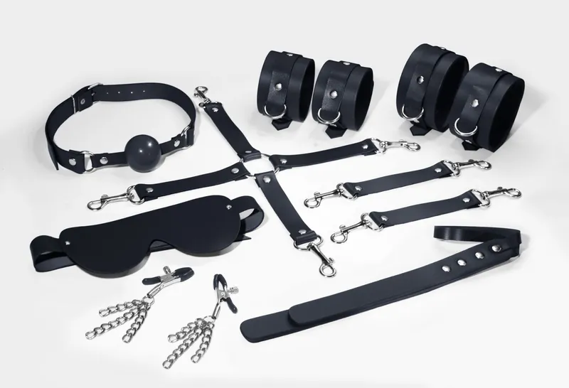 Набір Feral Feelings BDSM Kit 7 Black: наручники, поножі, конектор, маска, паддл, кляп, затискачі